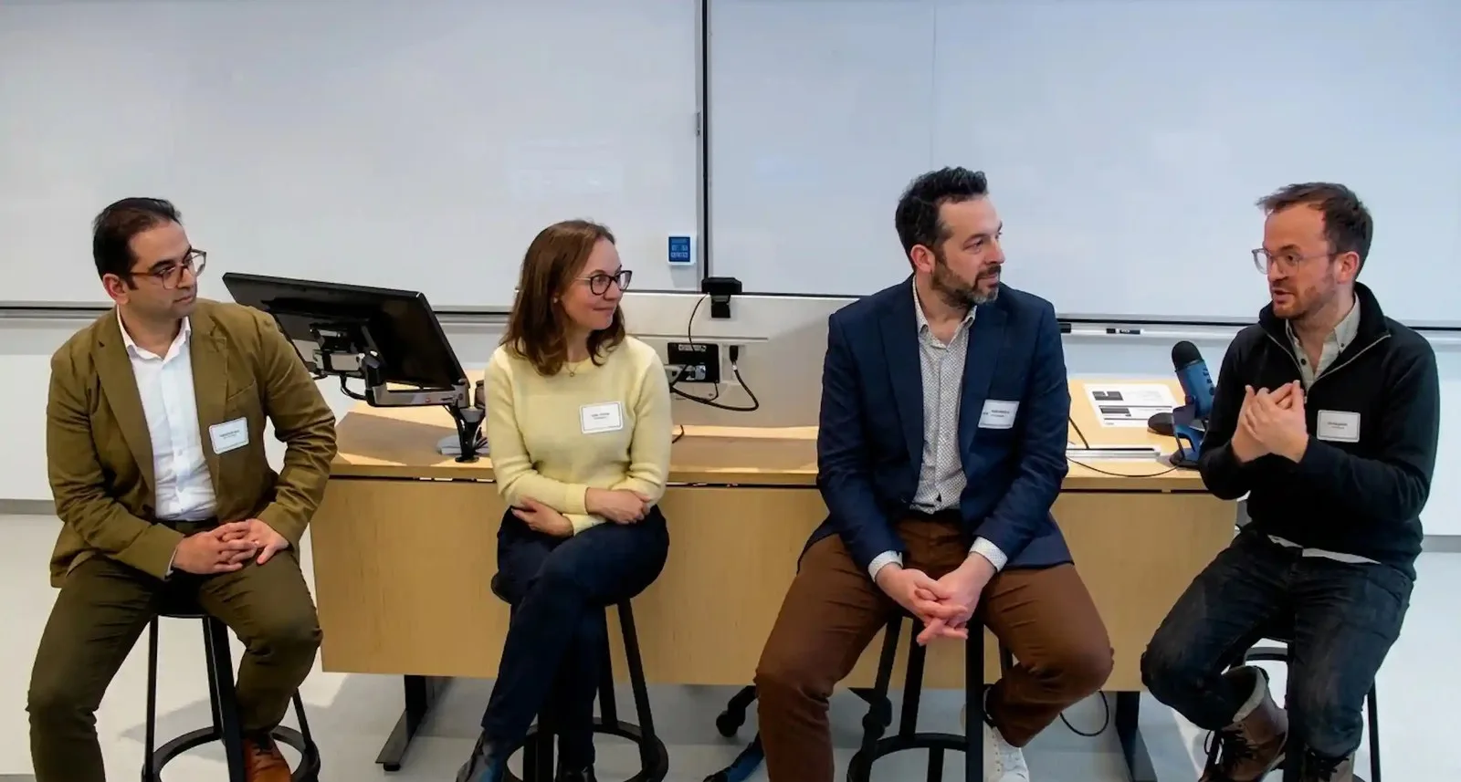 Four people talking at a roundtable