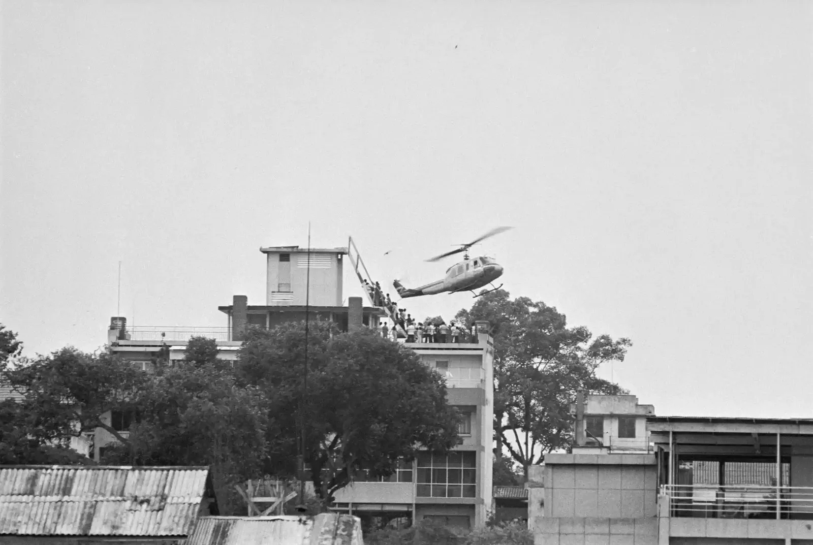 A helicopter is seen hovering over a building.