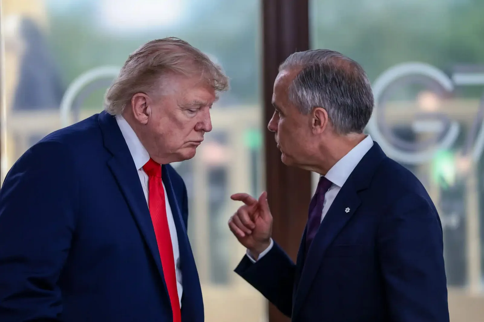 Two white men in suits having a conversation