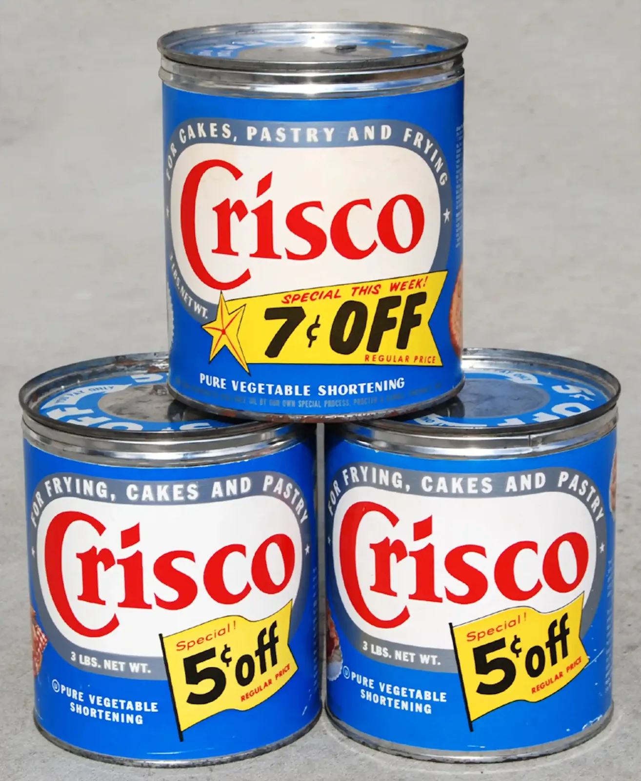 A stack of three cans labeled 'Crisco.'