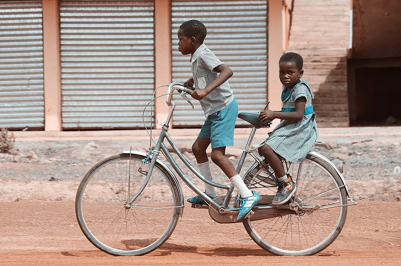 Children riding a bike in Ghana