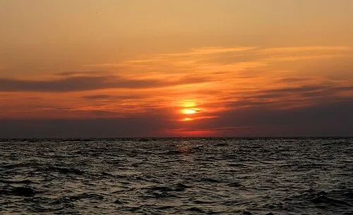 Sunset over the Delaware Bay at Sunset Beach, New Jersey, U.S., seen through cirrus clouds