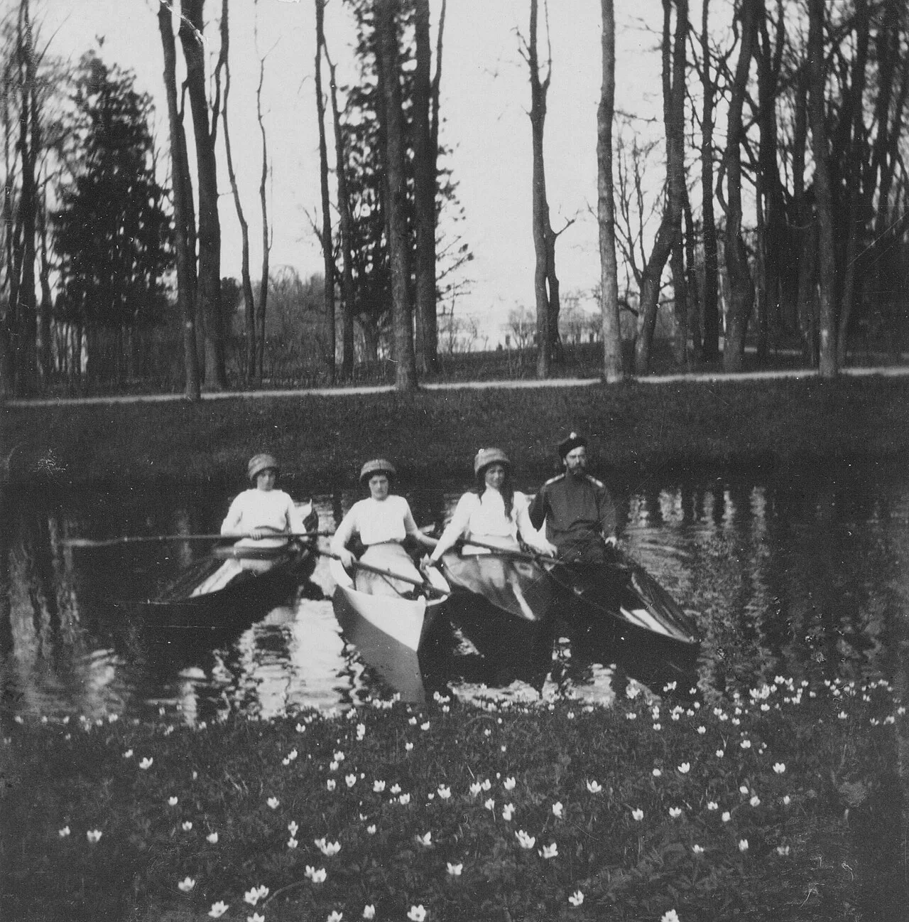 The tsar Nicholas II and three of his daughters canoeing and kayaking in the Alexander Park, May 1913.