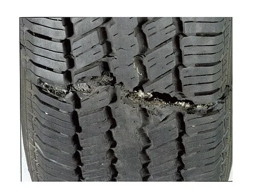 Automobile tire damaged after an impact.