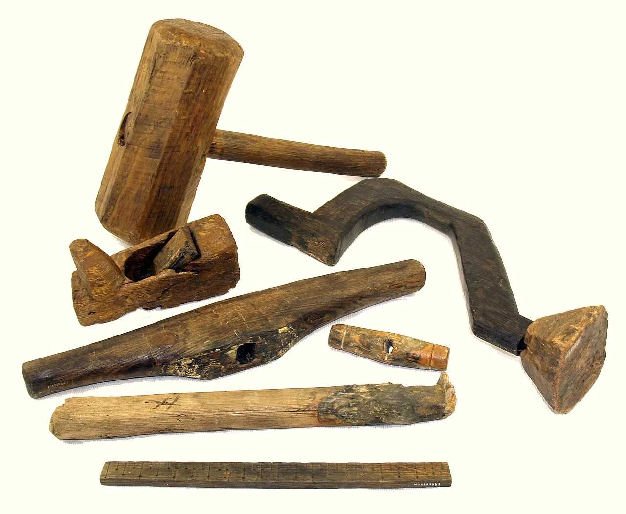 A wooden drill brace and other carpentry tools including a mallet, plane, spokeshave, and rudimentary ruler) found on board the 16th century warship Mary Rose